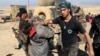 FILE - Iraqi special forces arrest a suspected Islamic State fighter in Mosul, Iraq, Feb. 25, 2017.
