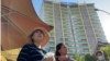 Sitanun Satsaksit stands in front of Mekong Gardens condominium where her brother, Wanchalearm Satsaksit, was allegedly abducted six months ago in Phnom Penh, Cambodia, on December 04, 2020. (Aun Chhengpor/VOA Khmer)