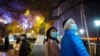 Duan Ling and her husband Fang Yushun walk on a street, almost a year after the global outbreak of the coronavirus disease (COVID-19) in Wuhan