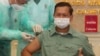 FILE - Cambodia's Lt. Gen. Hun Manet, a son of Prime Minister Hun Sen, thumbs up as he receives a shot of the COVID-19 vaccine at Calmette hospital in Phnom Penh, Cambodia, Wednesday, Feb. 10, 2021. (AP Photo/Heng Sinith)