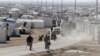 FILE - Syrian refugees walk at the Al Zaatari refugee camp in the Jordanian city of Mafraq, near the border with Syria, Dec. 7, 2014.