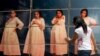 FILE -A woman adjusts cardboard boxes assembled to form a display highlighting the issue of teenage pregnancy outside the National Population Council's headquarters in Mexico City, Thursday, May 29, 2014. 