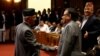 Nepal's Prime Minister Khadga Prasad Sharma Oli, also known as KP Oli, shakes hand with Chairman of the Unified Communist Party of Nepal (Maoist) Pushpa Kamal Dahal, also known as Prachanda, (R) as he returns after announcing his resignation at the parlia