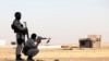 FILE - Kurdish Peshmerga troops participate in an intensive security deployment against Islamic State militants in a village on the outskirts of the province of Nineveh near the border province of Dohuk, Iraq, Aug. 9, 2014. 