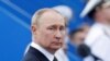 FILE PHOTO: Russia's President Vladimir Putin attends a parade marking Navy Day in Saint Petersburg, Russia