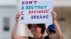 Trump ImmigrationJulia Paley, of Arlington, Va., with the DMV Sanctuary Congregation Network, holds up a sign during a rally supporting Deferred Action for Childhood Arrivals, or DACA, outside the White House in Washington, Sept. 4, 2017. 