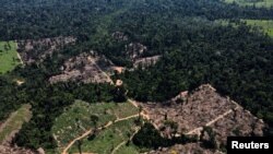 FILE - A view shows a deforested area in the middle of the Amazon Forest near the BR-230 highway, known as Transamazonica, in the municipality of Uruara, Para, Brazil, July 14, 2021. 