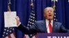 U.S. Republican presidential candidate and real estate mogul Donald Trump holds up his financial statement showing his net worth as he formally announces his campaign for the 2016 Republican presidential nomination in New York, June 16, 2015.