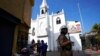 FILE - A Sri Lankan police officer stands guard outside at a church during Christmas festivities in Colombo, Sri Lanka, Dec. 25, 2021. On Dec. 25, 2023, Sri lanka granted amnesty to 1,000 convicts to mark Christmas.