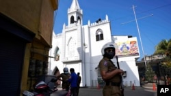 FILE - A Sri Lankan police officer stands guard outside at a church during Christmas festivities in Colombo, Sri Lanka, Dec. 25, 2021. On Dec. 25, 2023, Sri lanka granted amnesty to 1,000 convicts to mark Christmas.