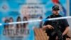 FILE - Armed police officers patrol a police cordon near the Manchester Arena in Manchester, May 24, 2017. 