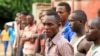 Suspected fighters are paraded before the media by Burundian police after clashes in the capital Bujumbura, Burundi, Dec. 12, 2015. 