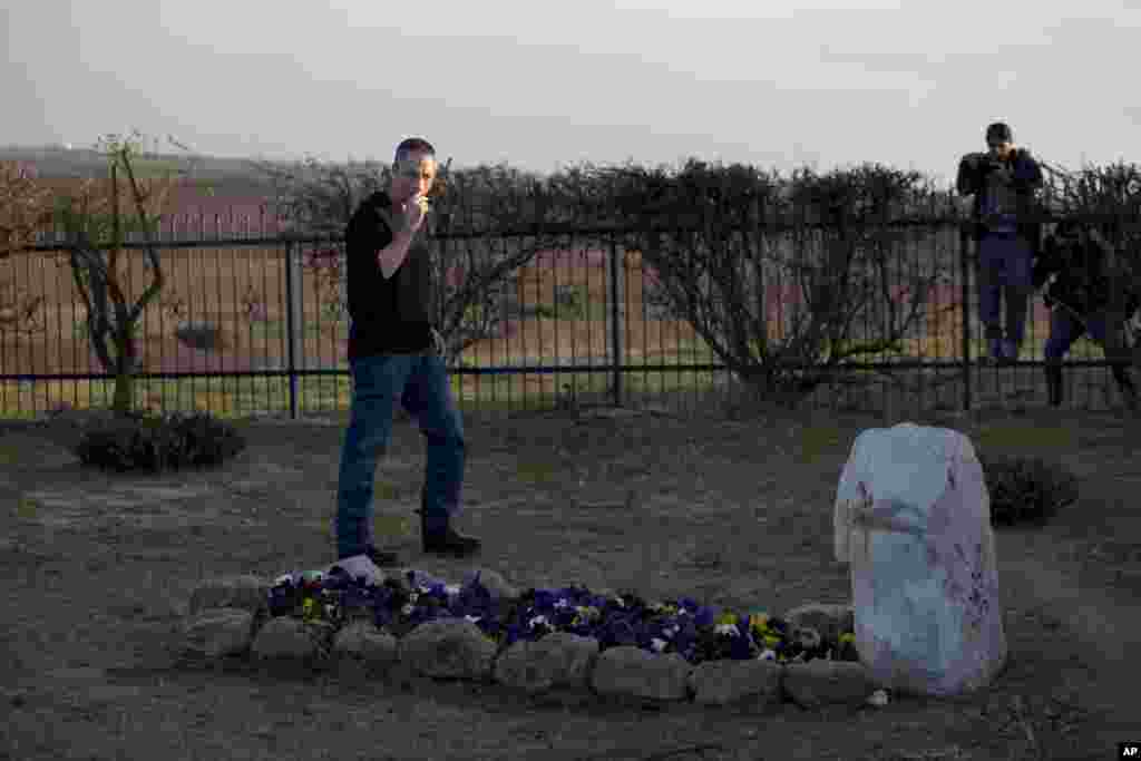 Gilad Sharon visits his mother's grave, where his father, the late Israeli Prime minister Ariel Sharon, is expected to be buried, outside Sharon's farm in Havat Hashikmim, southern Israel, Jan. 11, 2014.