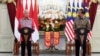 In this photo released by Indonesian Presidential Palace, Malaysian Prime Minister Ismail Sabri Yaakob, left, speaks as Indonesian President Joko Widodo looks on during a press conference following their meeting at Merdeka Palace in Jakarta, Indonesia, Friday, April 1, 2022. 