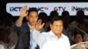 Presidential candidate Prabowo Subianto, right, and his running mate Gibran Rakabuming Raka who is also the eldest son of Indonesian President Joko Widodo, wave at supporters upon arrival to attend a televised presidential candidates' debate in Jakarta, Indonesia, Jan. 7, 2024. 
