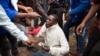 A man holds his South African identity document after being attacked by a mob in Pretoria, South Africa, Feb. 24, 2017. 