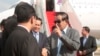 Cambodian Prime Minister Hun Sen, second from right, talks with his government offers as he arrives from Laos, at the airport in Phnom Penh, Cambodia, Saturday, Aug. 12, 2017. Hun Sen, who threatened Friday to use force over a border crisis with neighboring Laos, has announced less than 24 hours later that he has peacefully resolved it. (AP Photo/Heng Sinith)
