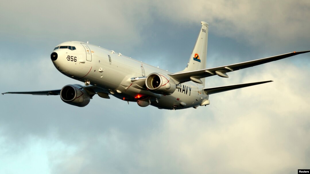 A P-8A Poseidon surveillance plane conducts flyovers above the Enterprise Carrier Strike Group on February 3, 2012 in this handout photo courtesy of the U.S. Navy.