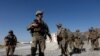 FILE - U.S. troops wait for their helicopter flight at an Afghan National Army (ANA) base in Logar province, Afghanistan, Aug. 7, 2018. 