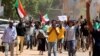 FILE - Sudanese protesters, pressuring transitional authorities for more reforms, march to the Cabinet’s headquarters in the capital, Khartoum, Sudan, Aug. 17, 2020. 