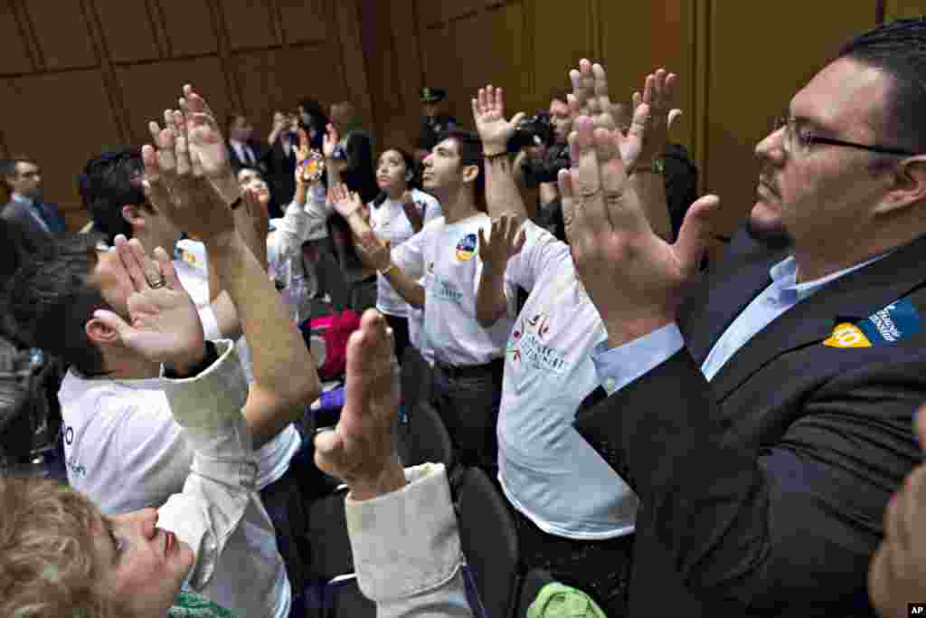 Immigration reform advocates pray before the start of a Senate Judiciary Committee meeting on Capitol Hill in Washington, May 9, 2013.
