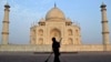 FILE - In this June 3, 2013, photo, a worker sweeps in front of Taj Mahal in Agra, India. Swarms of insects are proliferating in the heavily contaminated waters of the Yamuna River, which flows behind the 17th century monument.
