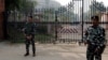 FILE - Security force personnel stand guard outside the parliament premises after a man jumped into the lawmakers' area of the lower house of India's parliament, in New Delhi, India, Dec. 13, 2023. 