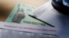 In this April 23, 2020, file photo, President Donald Trump's name is seen on a stimulus check issued by the IRS to help combat the adverse economic effects of the COVID-19 outbreak, in San Antonio. President Donald Trump, Treasury Secretary Steven…