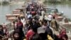 Displaced Sunni people fleeing Ramadi cross a bridge outside Baghdad, May 24, 2015. Iraqi forces recaptured territory from advancing Islamic State militants near the recently fallen city of Ramadi on Sunday.