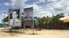 A portrait of the late Kem Ley is seen on a road in his hometown in Tram Kak district in Leay Bor commune, Takeo province, Cambodia, July 9, 2018. (Hul Reaksmey/VOA Khmer) 