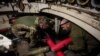 Ukrainian servicemen of the 92nd separate assault brigade load shells in an M109 self-propelled howitzer before firing towards Russian troops, amid Russia's attack on Ukraine, near the town of Vovchansk in Kharkiv region, Ukraine May 20, 2024. 