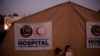 FILE - Rohingya refugee children from Myanmar are seen in front of a Malaysian field hospital near Cox's Bazar, Bangladesh, Jan. 27, 2018. The IFRC has opened two such facilities in Cox's Bazar to help fight the spread of COVID-19.