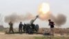 FILE - Iraqi security forces fire at Islamic State militants positions from villages south of the Islamic State group-held city of Mosul, Iraq. 