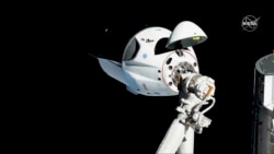 FILE - The SpaceX Crew Dragon capsule is pictured, March 3, 2019, about 20 meters (66 feet) from the International Space Station's Harmony module.