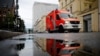 FILE - An emergency vehicle drives in front of the central building of the Charite hospital where the Russian opposition leader Alexei Navalny is being treated, in Berlin, Germany, Sept. 2, 2020.