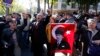 FILE - Relatives of detained military officers hold a portrait of Mustafa Kemal Ataturk, founder of modern Turkey, shouting slogans in front of a courthouse in Ankara, Oct. 9, 2013. 
