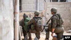 This handout picture released by the Israeli army on June 20, 2024 shows Israeli army soldiers operating in the Gaza Strip amid the ongoing conflict in the Palestinian territory between Israel and Hamas.