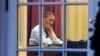 President Barack Obama works at his desk in the Oval Office of the White House in Washington, Jan. 27, 2014, ahead of Tuesday night's State of the Union speech.