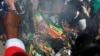 Supporters of the opposition Movement for Democratic Change party (MDC) of Nelson Chamisa burn an election banner with the face of Zimbabwe's President Emmerson Mnangagwa in Harare, Zimbabwe, Aug. 1, 2018.