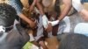 An image grab taken from AFP TV on Jan. 17, 2019, shows medics looking after an injured man after police fired tear gas at hundreds of protesters marching towards the presidential palace in the capital Khartoum demanding the resignation of the Sudanese president.