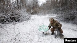 Військовик ЗСУ використовує супутниковий інтернет на передовій, Кремінна, 6 січня 2023. REUTERS/Clodagh Kilcoyne