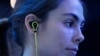 FILE - A young woman is seen wearing headphones at the Consumer Electronics Show in Las Vegas Jan. 6, 2015.