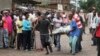 Men carry a dead body in the Nyakabiga neighborhood of Bujumbura, Burundi, where a number of people were found shot dead a day after the government said an unidentified group had carried out coordinated attacks on three military installations, Dec. 12, 2015.
