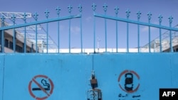 FILE - Locked gates are seen at a shuttered school run by the United Nations Relief and Works Agency (UNRWA) in Gaza City, in the Palestinian territories, March 7, 2020.