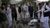 Men try to recognize the victims from the remains of their clothes at the site of three suicide attacks, in Kabul, Afghanistan, Jun 3, 2017.