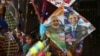 FILE - An Indian girl stands near a kite with portraits of India's Prime Minister Narendra Modi and U.S. President Barack Obama, for sale at a shop ahead of the Hindu festival Makar Sakranti, also known as kite festival, in Hyderabad, India, Jan. 12, 2015.