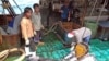 FILE - Fishermen at the Majuro port in the Marshall Islands unload yellowfin tuna on Feb. 1, 2018, for Luen Thai Fishing Venture, one of the companies that was supplying fish that entered the supply chain of Sea To Table. 