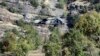 FILE - A Turkish military helicopter flies at low altitude along a mountain in Cukurca, near the Iraqi border in southeastern Turkey, where thousands of Turkish troops had launched a ground and air offensive against PKK fighters, Oct. 21, 2011.