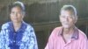 Hem Savy, 66, the commune chief from ruling Cambodian People’s Party and Men Saron, 76, deputy commune chief from Cambodia National Rescue Party (CNRP), inside a small hall at a local pagoda used for voter registration, located along the road next to Mekong river in Orey commune, Stung Treng province, on October 19, 2017. (Sun Narin/VOA Khmer)