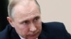 Russian President Vladimir Putin listens during a meeting in Moscow, Russia, Friday, April 13, 2018. The Kremlin says Russian President Vladimir Putin and French President Emmanuel Macron have agreed to coordinate their actions to avoid further military escalation in Syria.